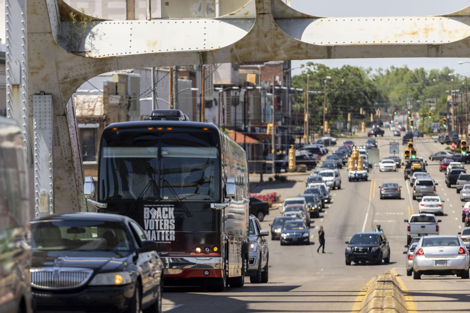 The Black Voters Matter bus leads a "votercade" -- a motorcade of voters -- across the Edmund Pettus Bridge, Saturday, May 8, 2021, in Selma, Ala. The group was moving between events in the John Lewis Advancement Act Day of Action, a voter education and engagement event held in Selma and Montgomery. (AP Photo/Vasha Hunt)