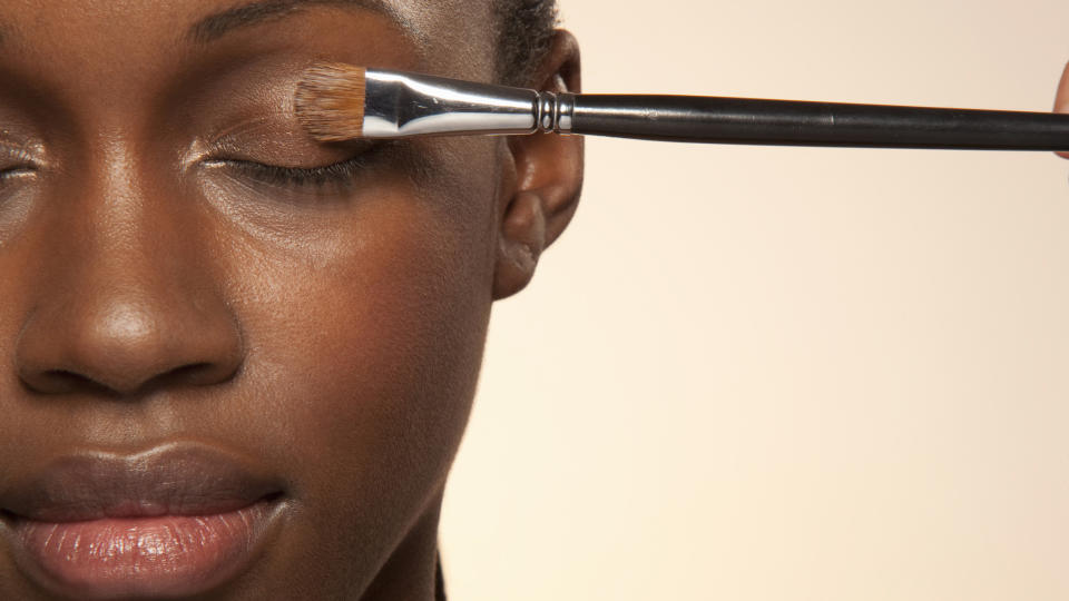 Black woman getting makeup done