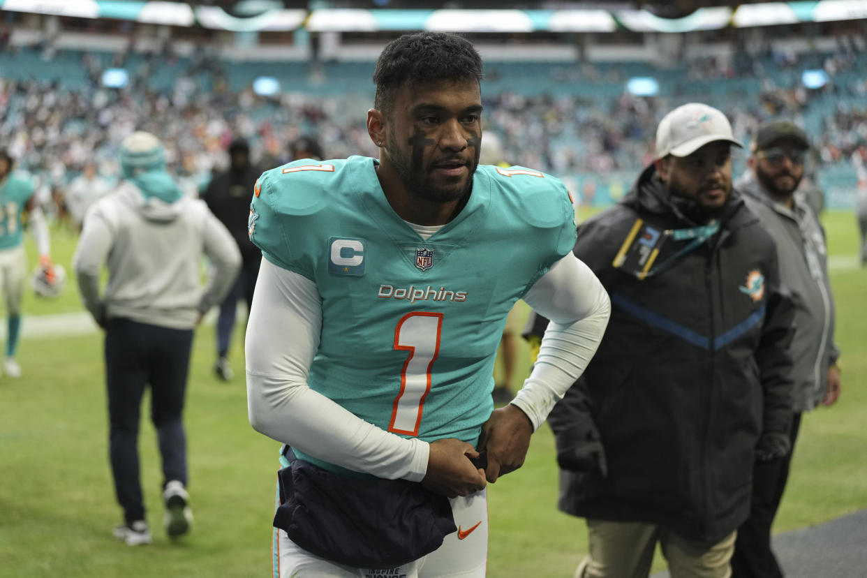 Miami Dolphins quarterback Tua Tagovailoa (1) walks off the field after an NFL football game against the Green Bay Packers, Sunday, Dec. 25, 2022, in Miami Gardens, Fla. (AP Photo/Jim Rassol)