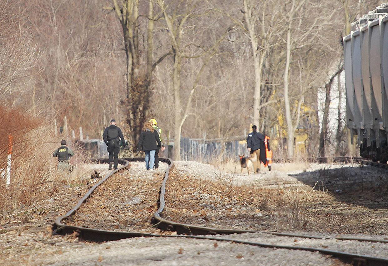 Area law enforcement and Ohio Special Response teams search around the railroad tracks near Cottage Street Saturday for Timothy Metcalf, 74, who has been missing since Feb. 20. TONY ORENDER/ for Ashland TIMES-GAZETTE.COM