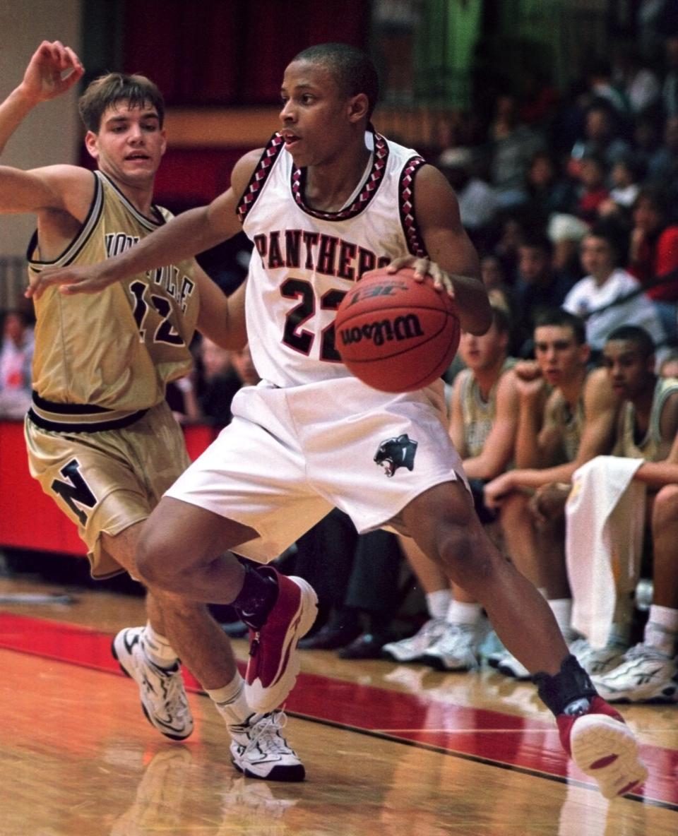 Jason Gardner (22), a senior North Central High School guard, who will attend Arizona in 1999 drives on Justin Anderson (12) in a scrimmage against Noblesville Thursday, November 19, 1998.