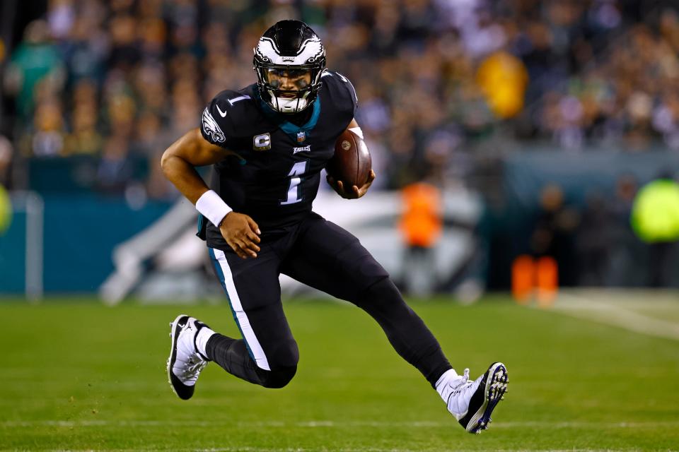 Philadelphia Eagles quarterback Jalen Hurts (1) runs for a first down during the first quarter of an NFL football game against the Green Bay Packers, Sunday, Nov. 27, 2022, in Philadelphia. The Eagles defeated the Packers 40-33. (AP Photo/Rich Schultz)