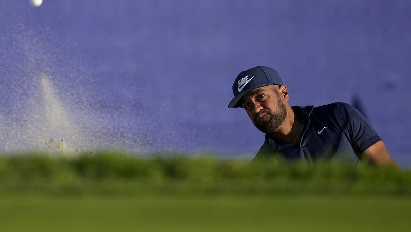 Tony Finau hits out of a bunker on the 18th hole of the South Course at Torrey Pines during the third round of the Farmers Insurance Open golf tournament, Friday, Jan. 26, 2024, in San Diego. 