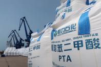 FILE PHOTO: Sacks of polyester-making chemicals, waiting to be shipped, are seen at Hengli Petrochemical's new refining, petrochemical complex at Changxing island in Dalian