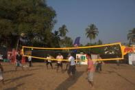 Tourists to Sunburn 2011 enjoy a game of volleyball on Candolim Beach, Goa