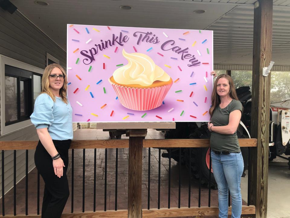 Danielle Blankenship, left, moved to 50 Park Drive in Hornell and opened Sprinkle This Cakery. The bakery features custom cakes, cupcakes and more. Tiffany Blankenship, Danielle's sister, helps display the new sign for the business.