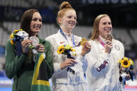 Gold medalist Lydia Jacoby, centre, of the United States, stands with silver medalist Tatjana Schoenmaker, left, of South Africa, and bronze medalist Lilly King, of the United States, after the final of the women's 100-meter breaststroke at the 2020 Summer Olympics, Tuesday, July 27, 2021, in Tokyo, Japan. (AP Photo/Matthias Schrader)