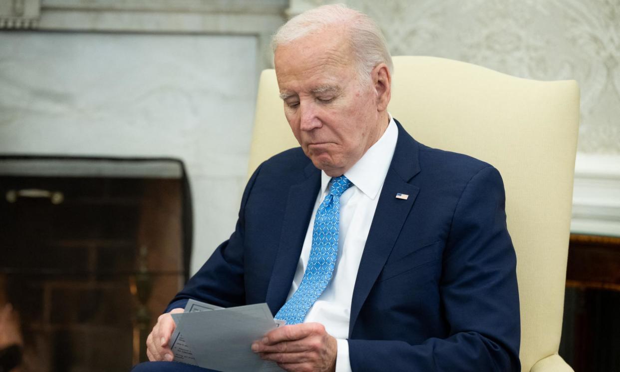 <span>President Joe Biden looks on during a meeting with Italian prime minister Giorgia Meloni in the Oval Office on Friday.</span><span>Photograph: Saul Loeb/AFP/Getty Images</span>