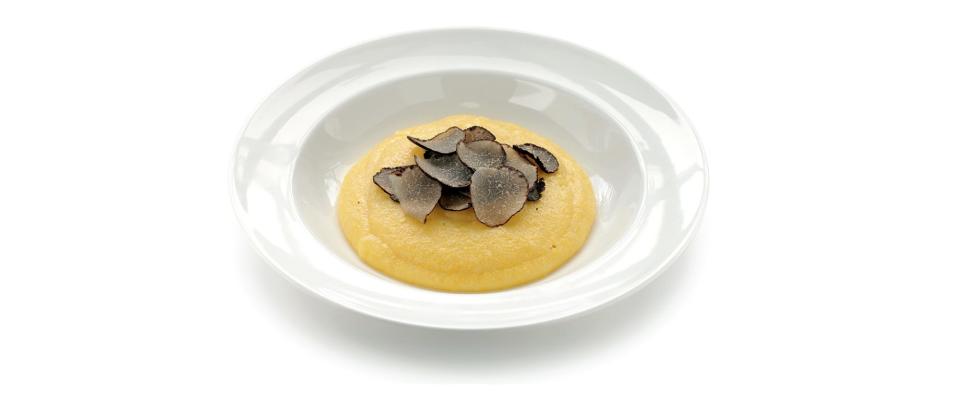 Black truffles served over polenta, a type of yellow cornmeal.