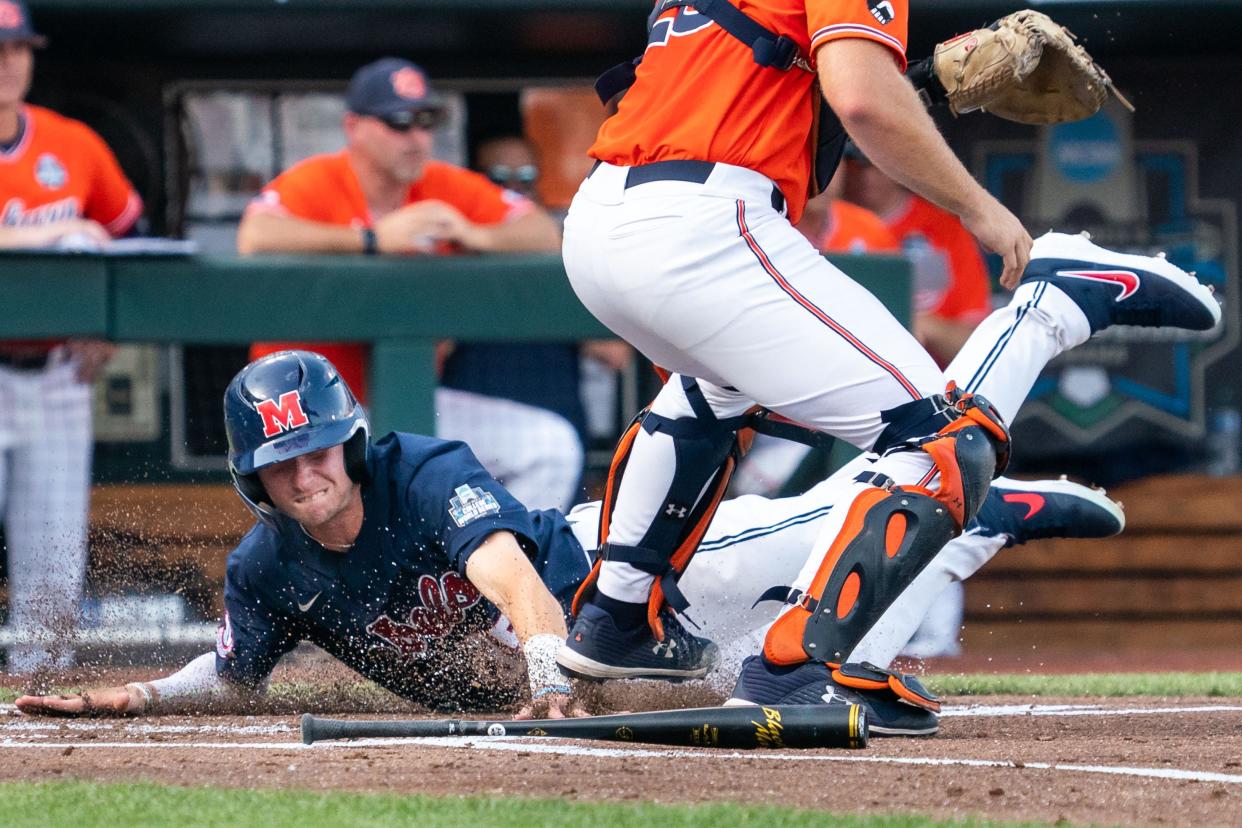 Jun 18, 2022; Omaha, NE, USA; Ole Miss Rebels left fielder Kevin Graham (35) slides across home plate to score against the Auburn Tigers during the first inning at Charles Schwab Field. Mandatory Credit: Dylan Widger-USA TODAY Sports
