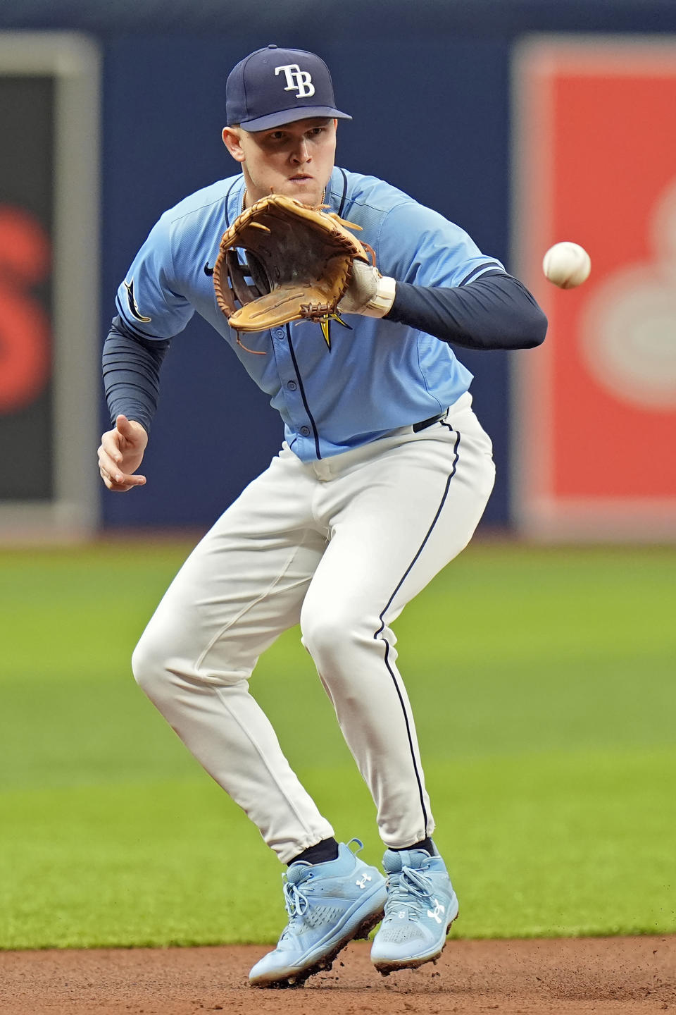 Tampa Bay Rays third baseman Curtis Mead, of Australia, fields a ground ball hit by Los Angeles Angels' Taylor Ward before throwing him out at first during the first inning of a baseball game Thursday, April 18, 2024, in St. Petersburg, Fla. (AP Photo/Chris O'Meara)