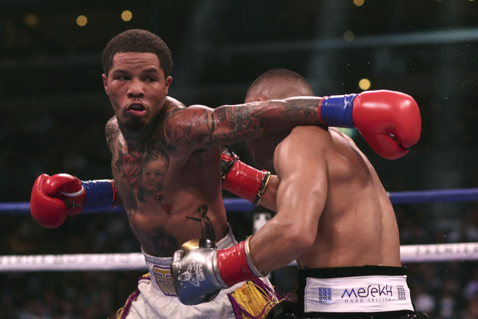 Gervonta Davis, left, throws a punch at Isaac Cruz during their WBC lightweight title boxing bout in Los Angeles Sunday, Dec. 5, 2021. (AP Photo/David Swanson)