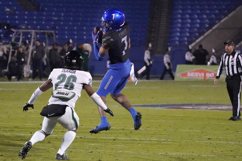 North Texas wide receiver Latrell Neville (7) catches a pass in front of Boise State running back Taylor Marcum (26) during the first half of the Frisco Bowl NCAA college football game Saturday, Dec. 17, 2022, in Frisco, Texas. (AP Photo/LM Otero)