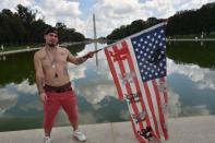 <p>A fan of the US rap group Insane Clown Posse, known as Juggalos, poses with a national flag as several thousand fans prepare on Sept. 16, 2017 to assemble near the Lincoln Memorial in Washingtonto protest at a 2011 FBI decision to classify their movement as a gang. (Photo: Paul J. Richards/AFP/Getty Images) </p>