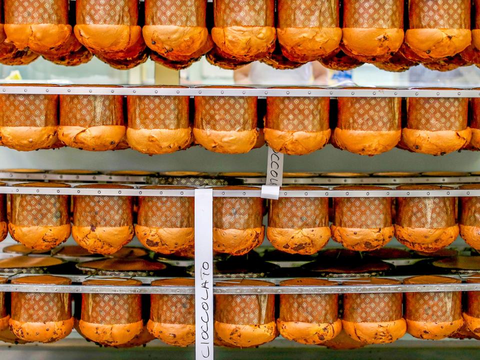 Panettone cakes are seen on a rack at the Pasticceria Giotto in Padua's Due Palazzi prison December 2, 2014. White-coated bakers are chopping nuts, dipping pastry into liquid chocolate and hanging freshly baked panettone Christmas cake upside down to preserve its domed shape. But when one of the all-male team steps outside to smoke, he is in a barred enclosure attached to Padua prison. Sweet smells have wafted through this building since 2005, when the local Giotto cooperative opened the 'Pasticceria Giotto', which they say is Italy's only bakery inside a jail. Picture taken December 2, 2014.