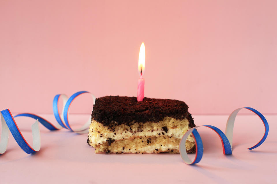 A piece of cake with a candle in it