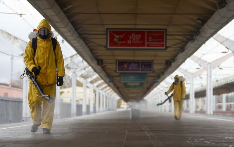 FILE PHOTO: Specialists sanitize a railway station amid the outbreak of the coronavirus disease in Moscow