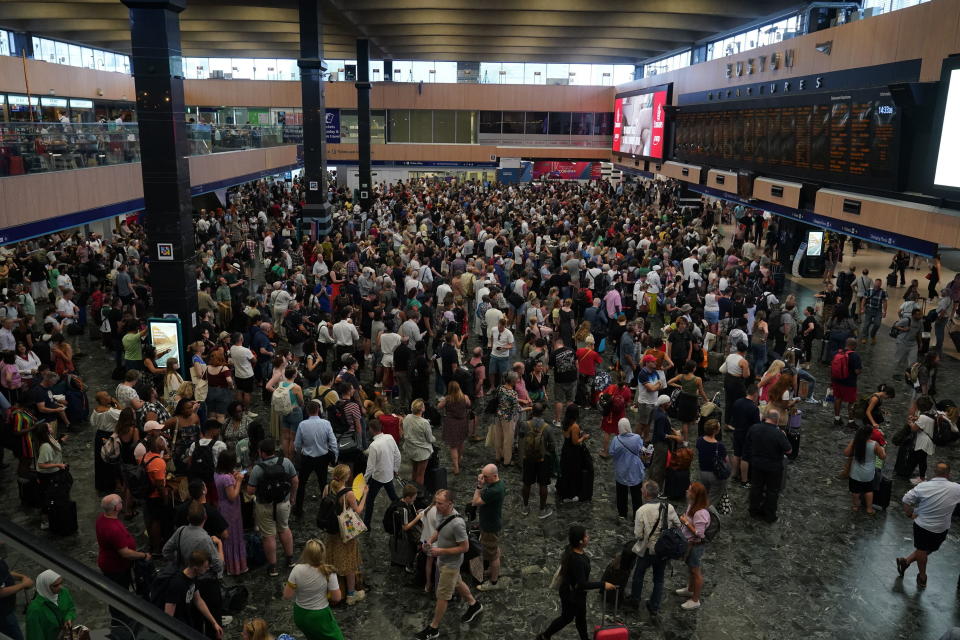 Passengers at Euston station in London, following train cancellations as high temperatures have brought severe disruption to rail services, Wednesday July 20, 2022. (Yui Mok/PA via AP)