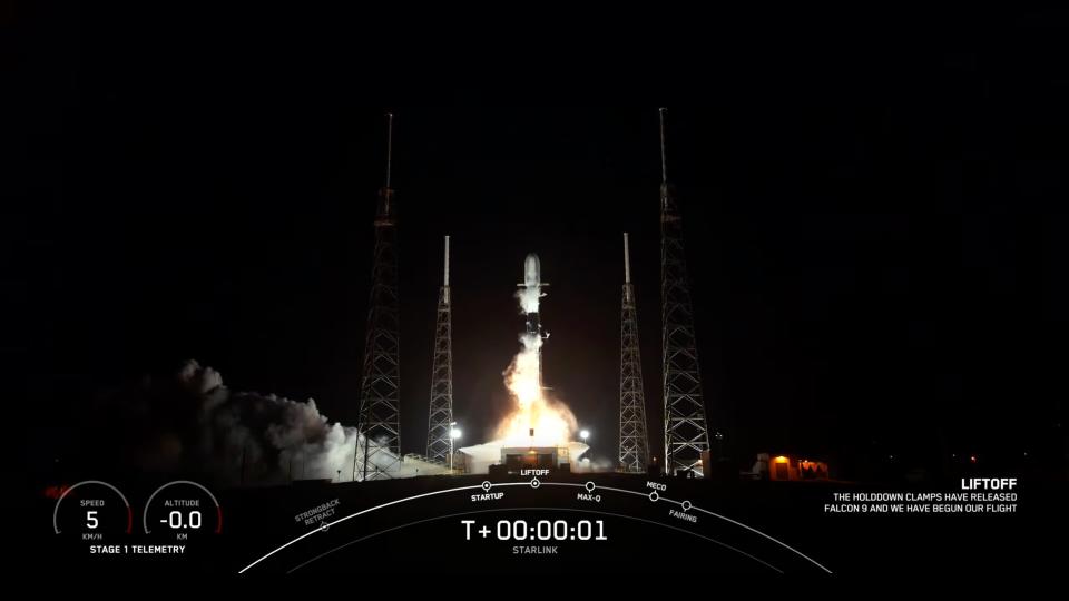 a black and white spacex falcon 9 rocket launches at night from florida