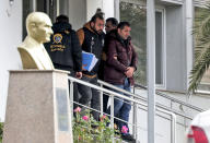 Turkish police officers escort suspects, accused of involvement of Nissan's former CEO Carlos Ghosn passage through Istanbul, after he fled Japan, in Istanbul, Friday, Jan. 3, 2020. Ghosn's daring escape spanned three continents and involved private planes, multiple passports and international intrigue. Turkey detained seven people Thursday as part of an investigation into how Ghosn passed through the country, and they were appearing in court Friday. The private DHA news agency reported that those detained were four pilots, a cargo company manager and two airport workers. (Ugur Can/DHA via AP)