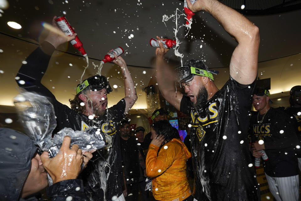 San Diego Padres relief pitcher Luis Garcia, right, celebrates with teammate relief pitcher Pierce Johnson after the Padres defeated the Los Angeles Dodgers 5-3 in Game 4 of a baseball NL Division Series, Saturday, Oct. 15, 2022, in San Diego. (AP Photo/Ashley Landis)