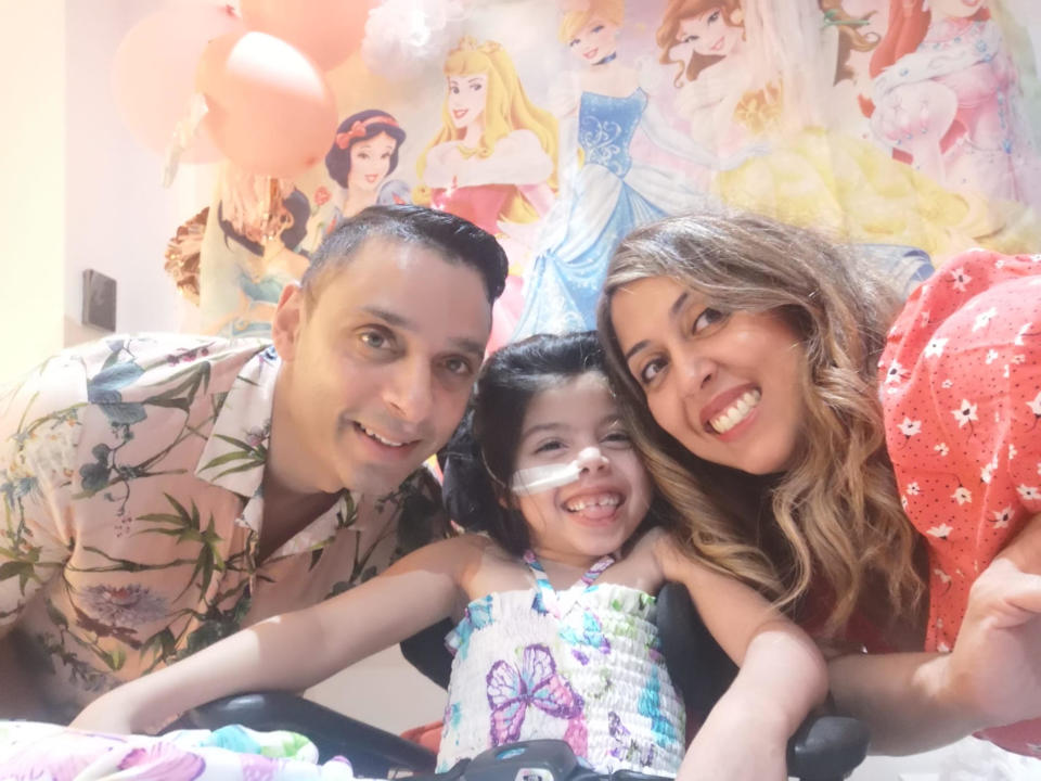 Sophia with her father, Satchit, and her mother, Sima. In September 2023, she celebrated her 7th birthday at home in Leicester, England with her family. (Image provided by the  Chauhan family)
