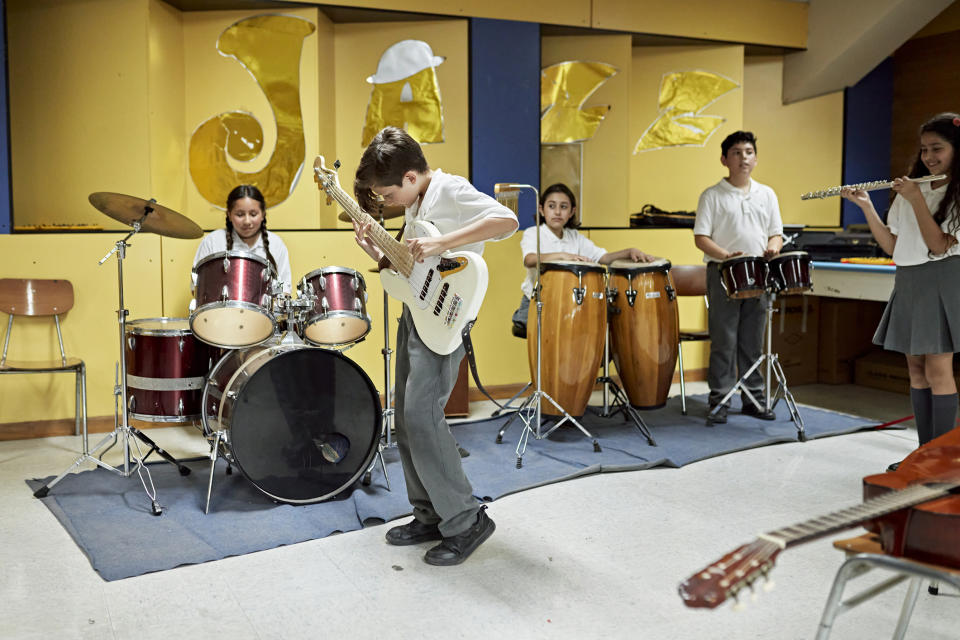 kids playing different instruments in a class