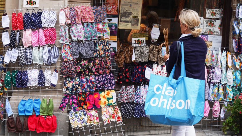 A woman stops to look at fabric face masks on sale in a shop in Stockholm, Sweden, on August 31, 2020. (Tom Little/AFP via Getty Images)