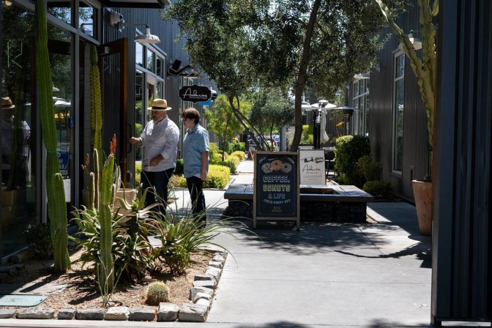 People enter a shop on the R Street corridor, a two-block retail, office and residential development in midtown Sacramento. Paul Kitagaki Jr./pkitagaki@sacbee.com