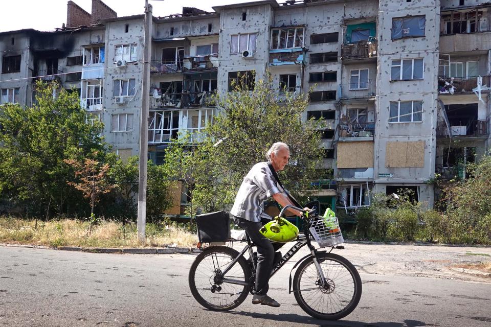 A cyclist rides by an apartment building that was heavily damaged by a rocket this week in Sloviansk, Ukraine.