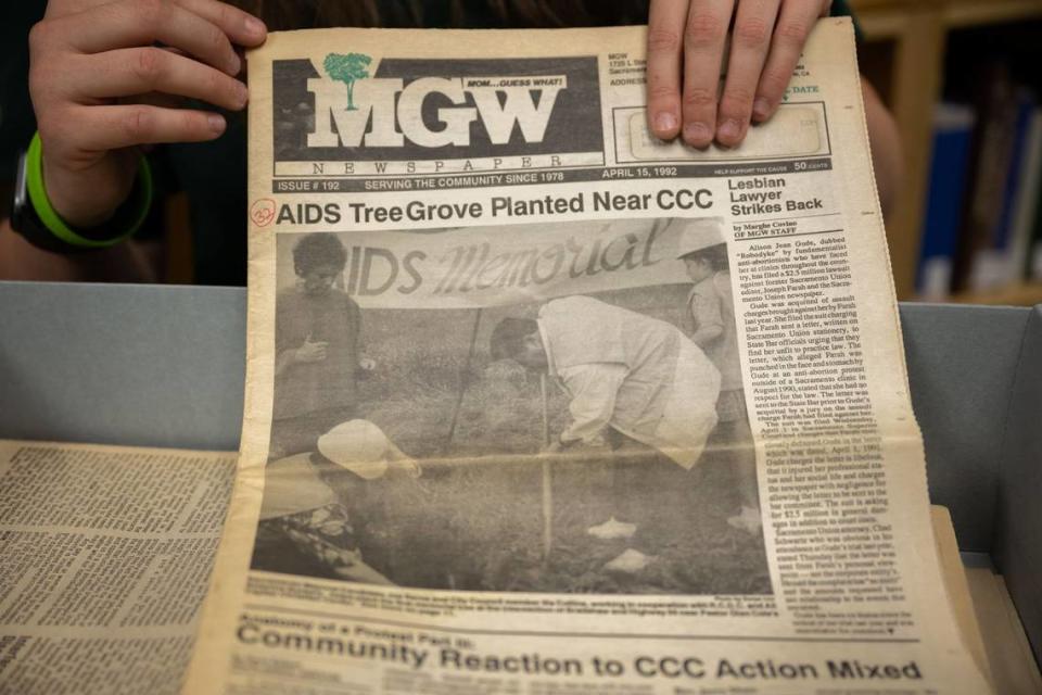 Center for Sacramento History archivist Sabrina Holeckoholds a Mom Guess What issue from 1992 that featured a cover of the late Sacramento Mayor Joe Serna during a tree planting for AIDS victims.