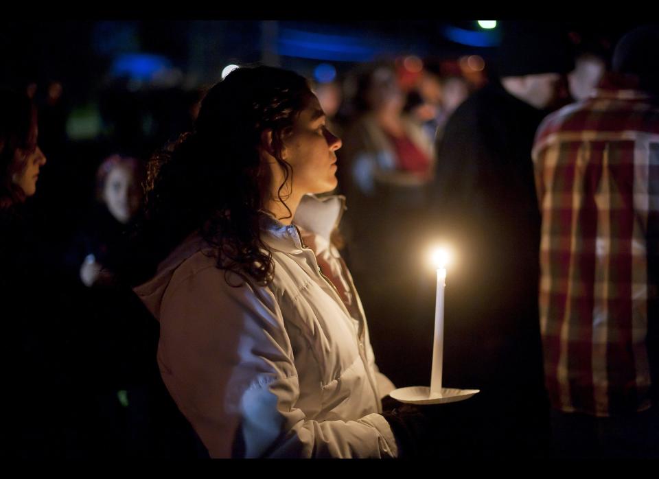 Students and those in the community embrace one another as they hold a candlelight vigil at St Mary's of the Assumption Church in Chardon, Ohio on Feb. 28, 2012.