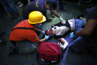 A injuried protestor lies on the floor during clashes with police as part of a protest against the political elites and the government after this week's deadly explosion at Beirut port which devastated large parts of the capital in Beirut, Lebanon, Saturday, Aug. 8, 2020. (AP Photo/Thibault Camus)