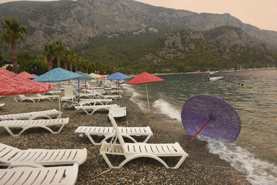 The Oren beach shortly after people were evacuated by boat after wildfires reached the nearby Kemerkoy Power Plant, a coal-fueled power plant, in Milas, Mugla in southwest Turkey, early Thursday, Aug. 5, 2021. (AP Photo)