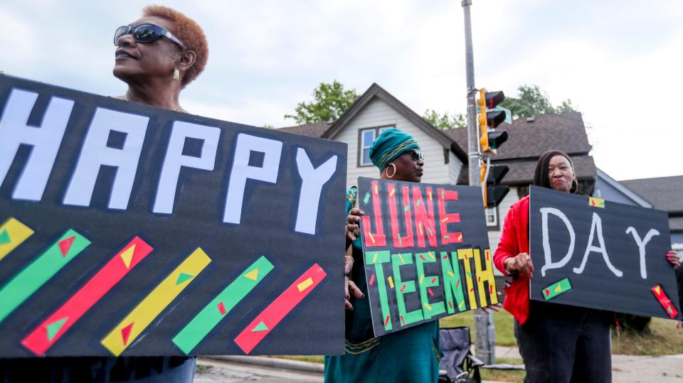 Toni Burt, left, Pamela Hardy, middle, and Sue Toney observe the Juneteenth Day parade and celebration on Saturday, June 19, 2021, in Milwaukee.