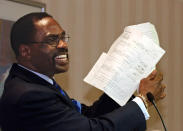 FILE - In this Jan. 29, 2004 file photo, former boxer, Rubin, "Hurricane" Carter, holds up the writ of habeas corpus that freed him from prison, during a news conference held in Sacramento, Calif. Carter, who spent almost 20 years in jail after twice being convicted of a triple murder he denied committing, died at his home in Toronto, Sunday, April 20, 2014, according to long-time friend and co-accused John Artis. He was 76. (AP Photo/Rich Pedroncelli, File)