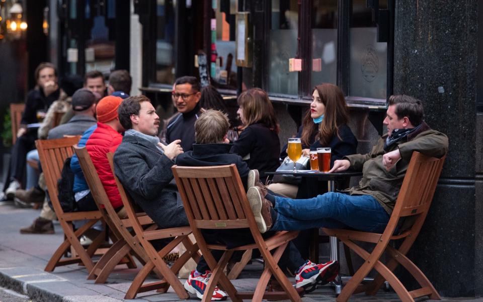 Drinkers outside a pub in Soho, London -  Dominic Lipinski/PA