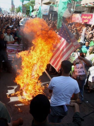 Palestinians burn the US flag in Rafah, during a protest against a film mocking Islam. Anti-US protests by crowds whipped into fury by a film that ridicules Islam's Prophet Mohammed erupted across the Arab world on Friday, leading to an explosion of violence in Sudan, Yemen and Lebanon