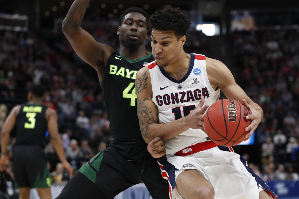 Gonzaga forward Brandon Clarke, right, looks to turn on Baylor guard Mario Kegler (4) during the first half of a second-round game in the NCAA men's college basketball tournament Saturday, March 23, 2019, in Salt Lake City. (AP Photo/Jeff Swinger)