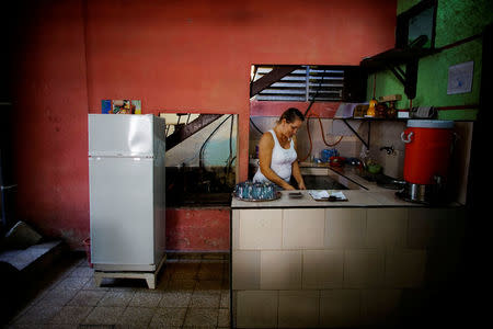 Aridania Rubens works beside a Chinese-made Haier refrigerator at her restaurant in Havana, Cuba, February 10, 2017. REUTERS/Alexandre Meneghini