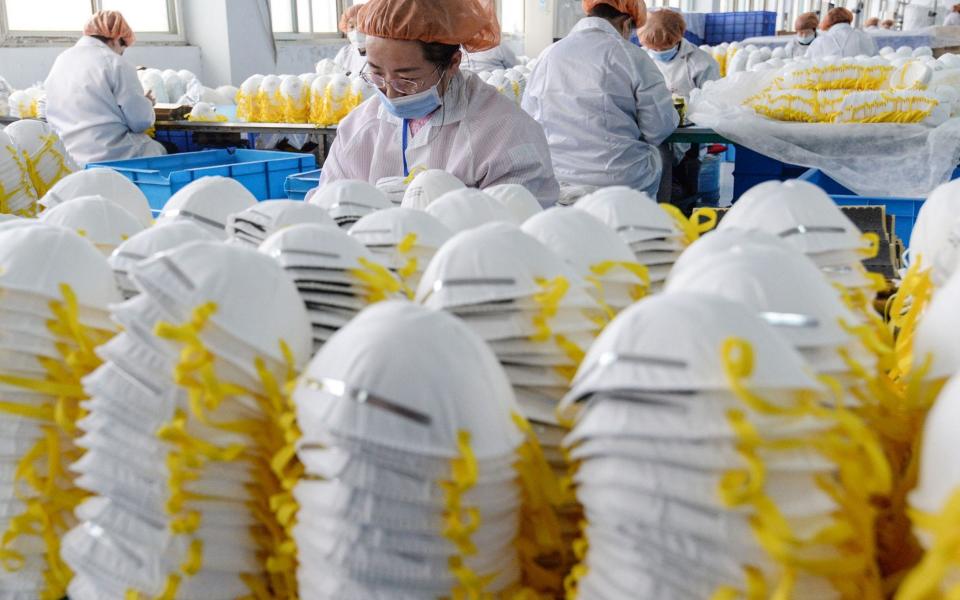 Workers producing face masks in China - STR /AFP