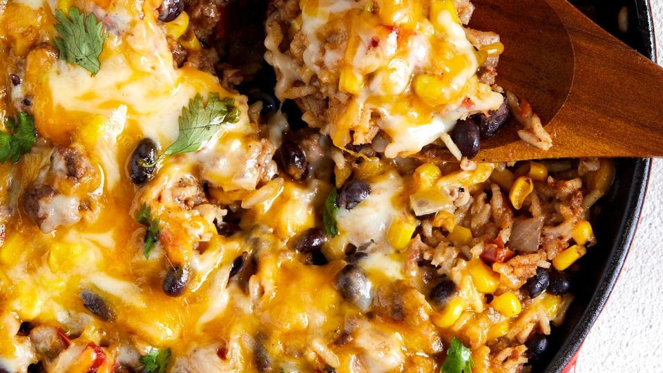 mexican beef 'n rice skillet topped with melty cheese and cilantro