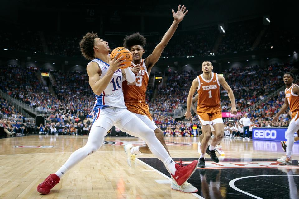 Kansas forward Jalen Wilson drives to the basket as Texas forward Dillon Mitchell defends during the Longhorns' win in the Big 12 Tournament championship game last Saturday. Both the No. 2-seeded Longhorns and No. 1-seeded Jayhawks will play their first-round NCAA Tournament games in Des Moines, Iowa.