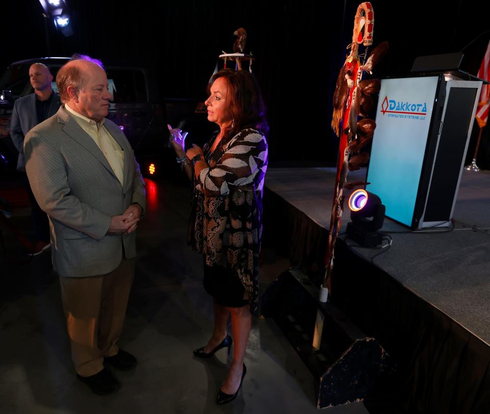Detroit Mayor Mike Duggan, left, talks with Andra Rush, the founder and CEO of Dakkota Integrated Systems in Detroit, before the official opening of the manufacturing plant on Thursday, May 5, 2022. The plant is located where the old Kettering High School used to be and now makes the instrument panels for various Jeep models.