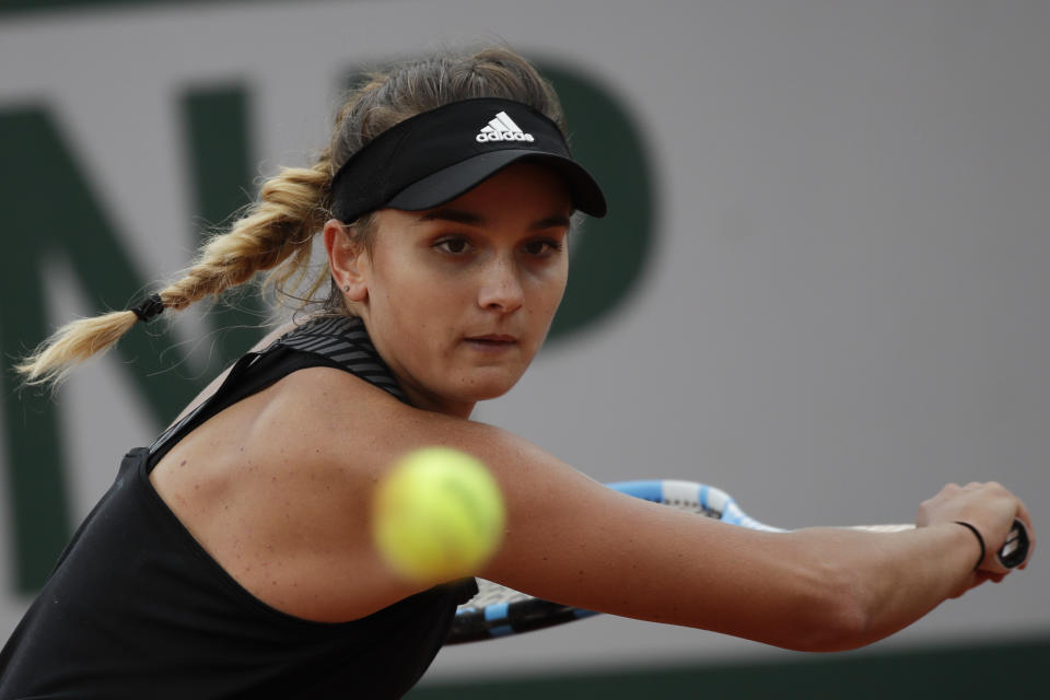 France's Clara Burel plays a shot against China's Zhang Shuai in the third round match of the French Open tennis tournament at the Roland Garros stadium in Paris, France, Saturday, Oct. 3, 2020. (AP Photo/Alessandra Tarantino)