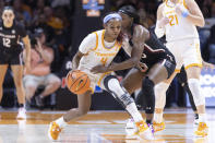 Tennessee guard Jordan Walker (4) drives as she is defended by South Carolina guard Raven Johnson during the first half of an NCAA college basketball game, Thursday, Feb. 23, 2023, in Knoxville, Tenn. (AP Photo/Wade Payne)