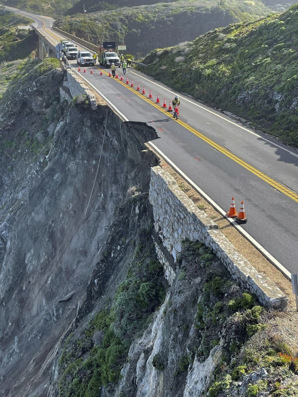 This photo provided by Caltrans shows a damaged section of Highway 1, Sunday, March 31, 2024, south of Rocky Creek Bridge in Big Sur, Calif. Authorities urged motorists to avoid the scenic highway after a section of the coastal route collapsed during an Easter weekend storm, forcing closures and stranding motorists near Big Sur, authorities said. (Caltrans District 5 via AP)