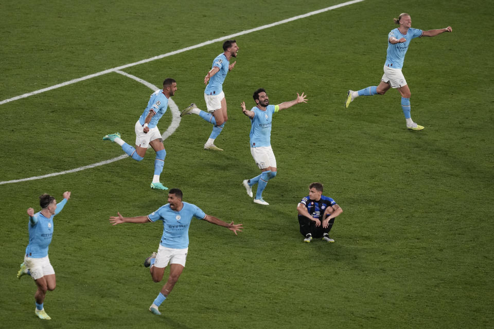 Manchster City players celebrate their 1-0 win at the end of the Champions League final soccer match between Manchester City and Inter Milan at the Ataturk Olympic Stadium in Istanbul, Turkey, Saturday, June 10, 2023. (AP Photo/Thanassis Stavrakis)