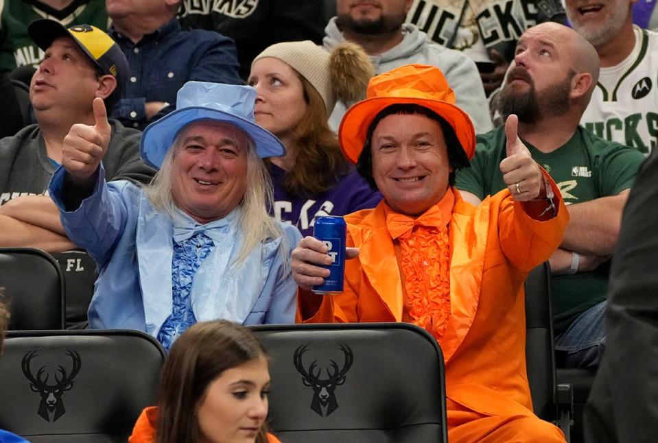 Fans dressed as the characters from the movie "Dumb and Dumber" for Halloween are seen during the first half of Milwaukee Bucks against the Detroit Pistons game in Milwaukee, Wis., on Monday, Oct. 31, 2022.