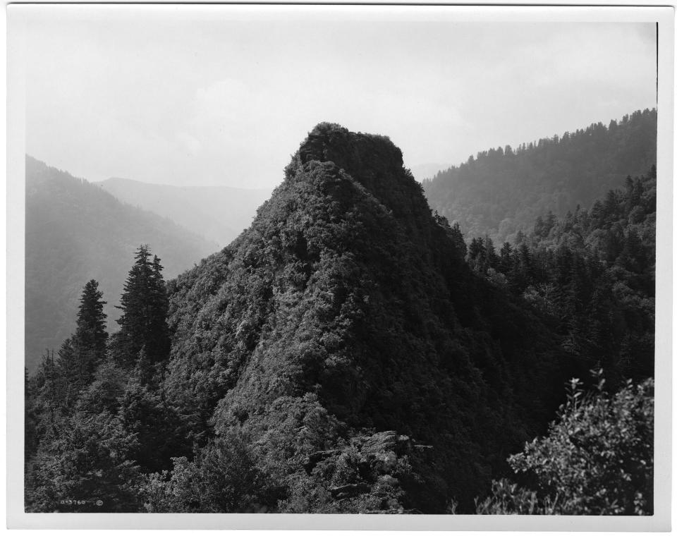 View of the Smokies’ Chimney Tops landmark circa 1920. This photo, presumed to be by George Masa, was colored and used as a postcard by Asheville Post Card Company.